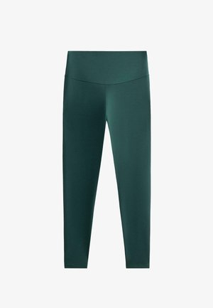 Donkergroene legging met een brede, platte tailleband. Gemaakt van glad, rekbaar stof. Strakke pasvorm zonder zichtbare patronen of accenten.