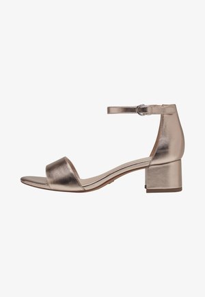 Metallic gold block-heel sandal with an ankle strap. Open toe design, smooth texture, and a wide toe band for support.
