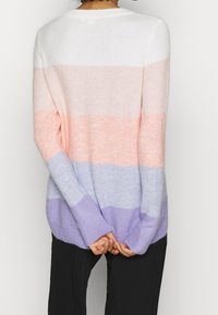 Pastel striped sweater featuring white, soft pink, and light purple colors. Made of a fluffy knit material with long sleeves and a relaxed fit.