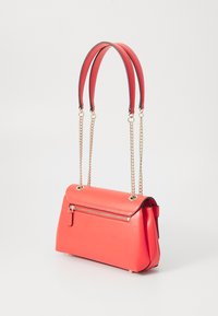 Red leather handbag with a structured shape, featuring a zippered front pocket, dual handles, and gold chain accents.