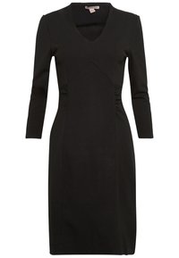 Robe noire midi avec un décolleté en V, des manches longues et une silhouette ajustée. Présente des détails froncés sur les côtés et est fabriquée en tissu extensible.