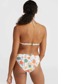 Bikini set featuring a floral pattern in orange, yellow, and green on a white background. Ties at the neck and a back clasp closure.
