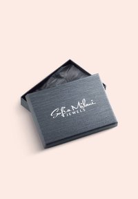 Graue Schmuckschatulle mit strukturierter Oberfläche und glattem Finish. Oben befindet sich ein weißes Logo mit der Aufschrift "Sofia Milani JEWELS". Das Innenfutter ist schlicht schwarz.