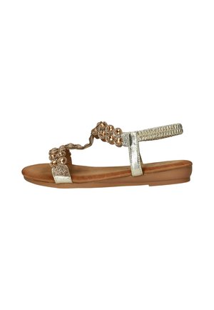 Platte sandaal met gouden metalen banden, versierd met gouden kralen en strass-steentjes, en een beige gevoerde zool.