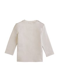 Camicia a maniche lunghe beige chiaro realizzata in morbido cotone, con collo rotondo e bottoni sulla spalla per facilitare l'abbigliamento, caratterizzata da una texture liscia.