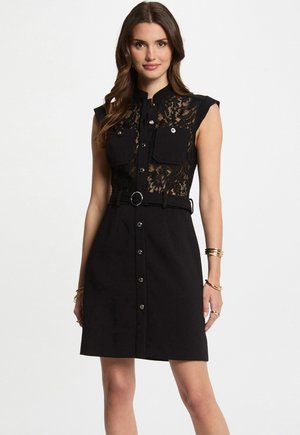 Black dress featuring a lace top with cap sleeves, two front pockets, a button-down design, and a belted waist for added structure.