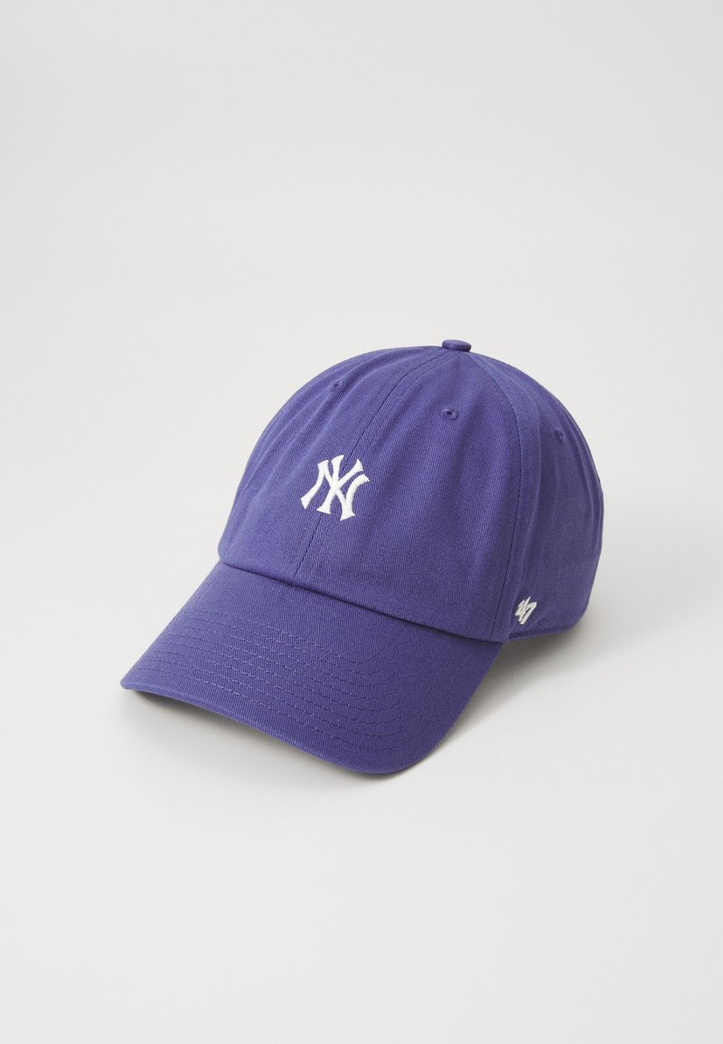 Purple baseball cap with a curved visor, featuring a white embroidered logo on the front and ventilation eyelets on the top.