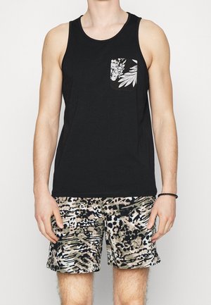 Black tank top with a floral pocket; paired with patterned shorts in tan, black, and green hues, featuring a loose fit and lightweight fabric.