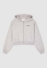 Felpa zipata cropped grigia chiara con cappuccio, tasche frontali, polsini a coste e testo "Aspettami" sul petto sinistro.