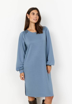 Blue long-sleeve dress in soft fabric with side slits and textured shoulder detailing. Casual fit, round neckline, and knee-length design.