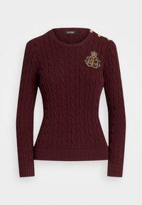 Pull bordeaux en maille torsadée avec ourlet et poignets côtelés. Présente des boutons dorés sur l'épaule et un logo brodé sur la poitrine.