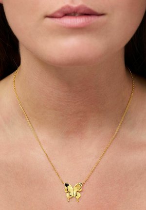 Gold necklace with a butterfly pendant featuring a black accent. Delicate chain with small links, worn around the neck.