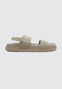 Sandalias beige con un diseño sin hebillas, que presentan dos correas de malla y una suela moldeada. Superficie texturizada con un tacón plano y sólido.
