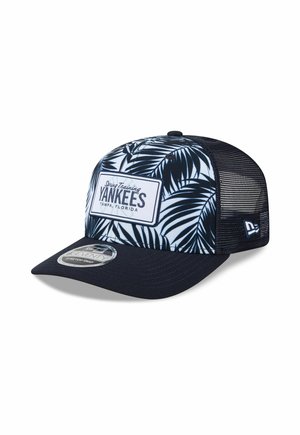 Baseball cap with navy blue brim and mesh back, front panel with navy palm leaf pattern and "Yankees Spring Training Tampa, Florida" patch.