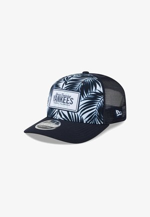 Baseball cap with navy blue brim and mesh back, front panel with navy palm leaf pattern and "Yankees Spring Training Tampa, Florida" patch.