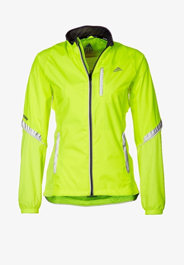 Veste Adidas jaune néon haute visibilité avec fermeture éclair intégrale à l’avant, bandes réfléchissantes sur les manches et les poches, et doublure noire au col.