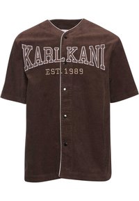 Camicia corta a maniche corte in corduroy marrone con chiusura a bottoni, caratterizzata da un logo ricamato bianco "KARL KANI" e una data di fondazione del 1989.