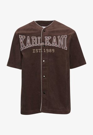 Brun kordflod skjorta med kort ärm och knäppning framtill, med vitt broderat "KARL KANI"-logotyp och ett etablerat datum 1989.