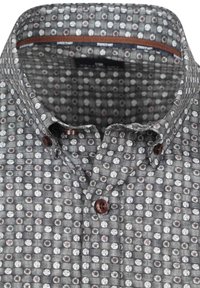 Grey patterned button-up shirt with circular floral designs in white and muted colors, featuring a spread collar and dark brown buttons.