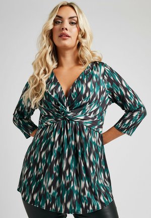 Multicolored top featuring a deep V-neck and three-quarter sleeves, with a twisted front detail and a flowing hemline. Fabric has a smooth texture.