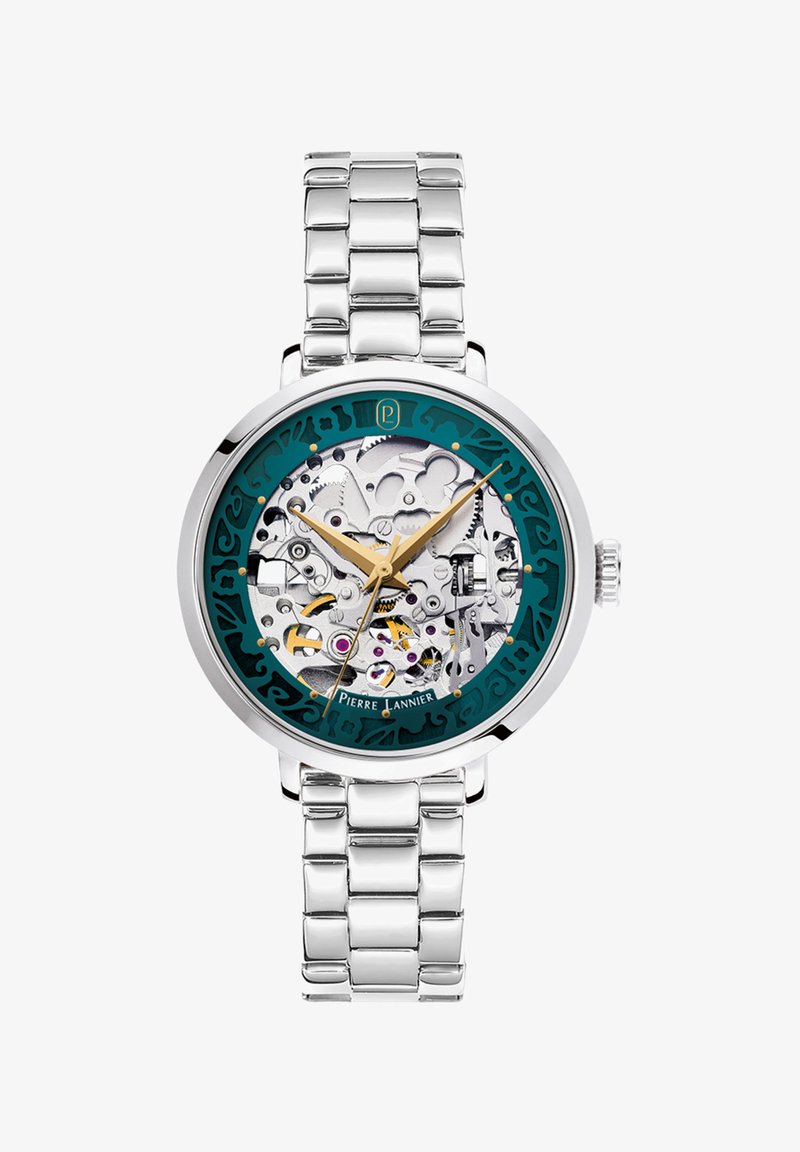 Reloj de acero inoxidable plateado con un dial transparente acentuado en teal que muestra intrincados mecanismos mecánicos y manecillas en tono dorado.