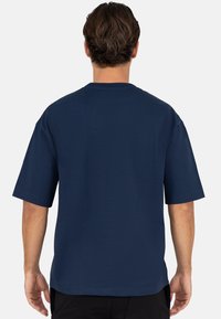Navyblauw T-shirt met korte mouwen, normale pasvorm, ronde hals, gemaakt van katoen, gladde textuur, met zichtbare stiksel-details en zonder afbeelding.