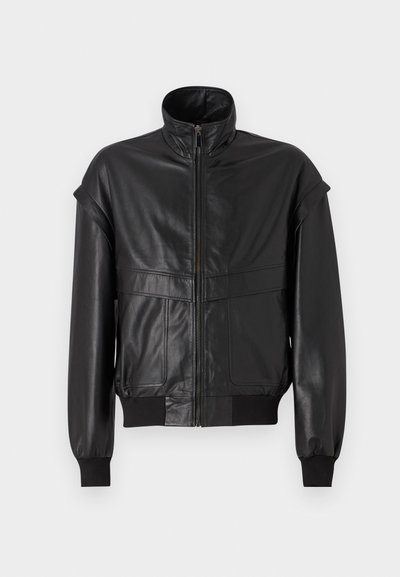 Black leather jacket with a high collar, zip front, and elastic cuffs. Features wide shoulders and two front pockets, textured finish.