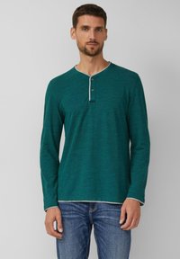 Türkisfarbenes Langarmshirt mit Rundhalsausschnitt, zwei Knopfverschlüssen und kontrastierenden grauen Akzenten. Weicher Stoff und lockerer Schnitt.