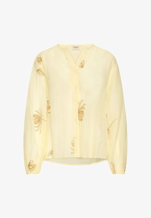 Hele kollane nööpidega pluus pikkade varrukatega ja peene pruuni lillemustriga, mis on kangale hajutatud.