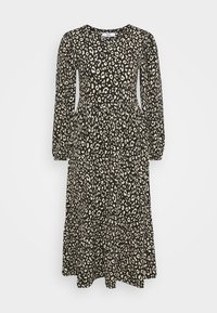 Robe midi à manches longues noire et blanche avec taille froncée et motif abstrait de léopard.