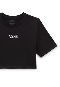 Sort cropped t-shirt lavet af bomuld, med rund halsudskæring og korte ærmer. Forsiden viser et hvidt broderet "VANS" logo.
