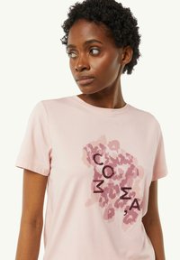 Pink cotton t-shirt featuring a leopard print pattern and the letters "COMA" in dark color, short sleeves, and a round neckline.