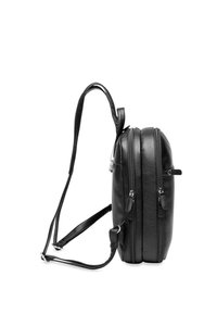 Black leather backpack with two exterior zipped compartments, adjustable straps, smooth texture, and rounded sides.