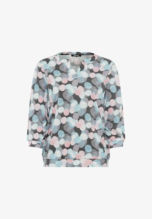 Grijze pullover met een V-hals en 3/4 mouwen. Heeft een patroon van grote, overlappende cirkels in lichtblauw en roze. Zachte stoftextuur.