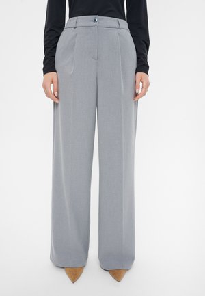 Pantalones de pierna ancha en gris, fabricados con tejido texturizado, que cuentan con un cierre de botón, bolsillos laterales y un acabado liso y ajustado.