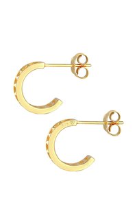 Boucles d'oreilles en or en forme de croissant, avec un bord texturé et une fermeture à tige. Fabriquées en argent sterling 925 avec une finition dorée.