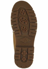 Braune Gummisohle mit strukturiertem Profil. Verfügt über das erhabene Logo "DOCKERS" und die Größe "40", die eingeprägt sind. Dicke Traktionsrillen für besseren Halt.