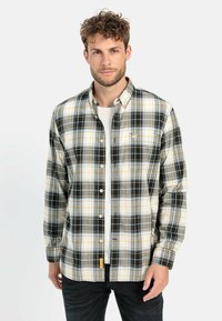 Langarm-Hemd aus kariertem Stoff in Schwarz, Gelb und Weiß. Verfügt über einen Button-Down-Kragen und ein kleines Logo-Akzent. Hergestellt aus weichem Material.