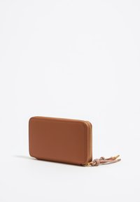 Brown leather wallet with a rectangular shape, gold zipper, and a knotted accent. Smooth texture with minimal design features.