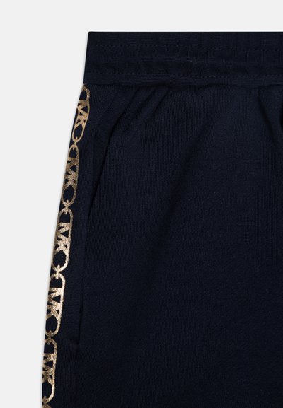 Pantalones deportivos azul marino con una tela texturizada, que cuentan con un patrón decorativo dorado a lo largo del costado y una cinturilla elástica para mayor comodidad.