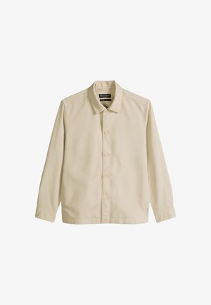 Beige long-sleeve button-up shirt with collar, five buttons, and a small tag on the lower side, displayed flat on a white background.