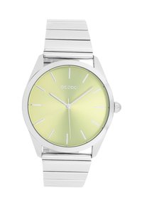 Montre en métal argenté avec un cadran rond vert clair. Dispose d'index horaires en bâton et d'une lunette lisse. Bracelet à maillons intégrés.