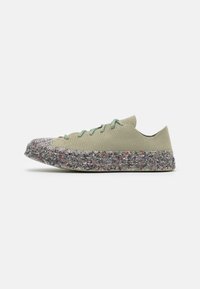 Baskets en textile vert avec un dessus texturé, fermeture à lacets et semelle extérieure multicolore à éclats. Design bas avec une pointe arrondie.