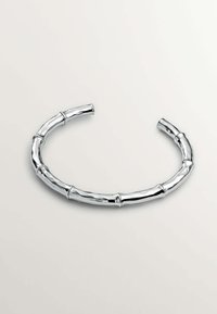 Pulsera de plata con un diseño inspirado en el bambú, con un acabado pulido y segmentos curvados que imitan las articulaciones del bambú.
