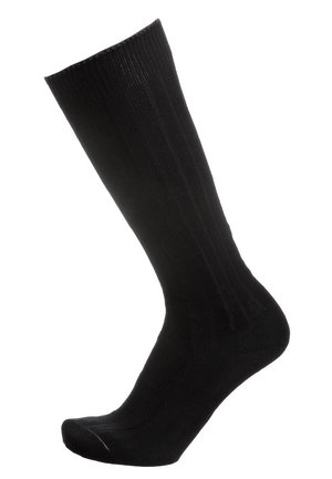 Calza a coste nera mostrata in posizione verticale con punta rinforzata e polsino elastico su sfondo bianco.