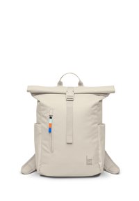 Beige roll-top backpack with front zipper pocket, colorful zipper pull, side pockets, top handle, and shoulder straps, branded "GOT BAG."