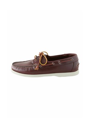 Brązowy męski skórzany but typu boatshoe z białą podeszwą i beżowym sznurowadłem związanym kokardką na górze, pokazany z boku na białym tle.