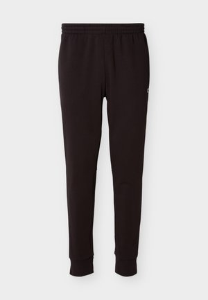 Juodos siaurėjančios sportinės kelnės su elastinga juosmens juosta ir rankogaliais, ant viršutinės šlaunies dalies esančiu mažu logotipu.