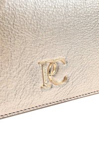 Gold metallic leather wallet featuring a textured surface, a raised logo, and contrasting stitching along the edge.