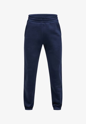 Marinblå sweatpants lavet af blødt materiale, med elastisk talje, sidelommer og tapered manchetter ved anklerne.